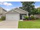 Charming home featuring a gray facade, well-manicured lawn, and a convenient two-car garage at 1460 Oldenburg Dr, Mount Pleasant, SC 29429