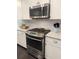 Modern kitchen featuring stainless steel oven, granite countertops, white cabinets, and tile backsplash at 1460 Oldenburg Dr, Mount Pleasant, SC 29429