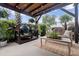 Covered outdoor living space featuring a large cooking grill, wooden furniture and mature landscaping at 1460 Oldenburg Dr, Mount Pleasant, SC 29429