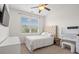 Cozy bedroom with a tufted headboard, a stylish vanity and a large window at 1582 Prince Edward St, Mount Pleasant, SC 29466