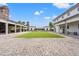 Expansive outdoor area with well-manicured lawn, brick pavers and shared community amenity buildings at 1582 Prince Edward St, Mount Pleasant, SC 29466