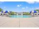 Large community pool with umbrellas and lounge chairs on sunny day at 1582 Prince Edward St, Mount Pleasant, SC 29466