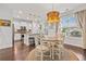 Bright dining area adjacent to the kitchen, featuring a round table, pendant lighting, and ample natural light at 1582 Prince Edward St, Mount Pleasant, SC 29466