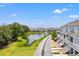 Beautiful townhomes overlooking a scenic pond with lush landscaping and clear blue skies at 1582 Prince Edward St, Mount Pleasant, SC 29466