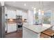 Modern kitchen with white cabinets, granite countertops, stainless steel appliances, and pendant lighting over the island at 1582 Prince Edward St, Mount Pleasant, SC 29466