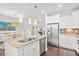 Contemporary kitchen showcasing white cabinets, stainless steel appliances, granite island with barstool seating, and open layout at 1582 Prince Edward St, Mount Pleasant, SC 29466