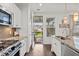 Bright kitchen with stainless steel appliances, granite countertops, and view to the outdoor patio at 1582 Prince Edward St, Mount Pleasant, SC 29466