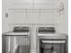 Laundry room featuring a set of stainless steel LG washer and dryer, with wire racks above at 1582 Prince Edward St, Mount Pleasant, SC 29466