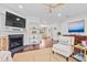 Open-concept living area with hardwood floors, fireplace, decorative shelving, and a seamless transition to the dining area at 1582 Prince Edward St, Mount Pleasant, SC 29466