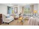 Cozy living room with neutral-toned furniture, patterned rug, and a view to a balcony, creating a relaxing space at 1582 Prince Edward St, Mount Pleasant, SC 29466