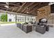 Inviting outdoor lounge area with ample seating, brick fireplace, and exposed timber beams at 1582 Prince Edward St, Mount Pleasant, SC 29466