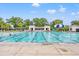 Community pool with clear blue water, covered seating, and lush tropical landscaping offers the perfect outdoor recreation at 1582 Prince Edward St, Mount Pleasant, SC 29466