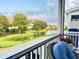 Relaxing screened porch with wicker furniture, and a view of the pond and community at 1582 Prince Edward St, Mount Pleasant, SC 29466