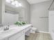 Bright bathroom features a spacious vanity and a decorative mirror with a toilet to the right at 1600 Long Grove Dr # 423, Mount Pleasant, SC 29464
