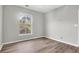 Bright bedroom featuring wood-look floors and a window with views of the trees at 1600 Long Grove Dr # 423, Mount Pleasant, SC 29464