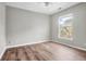 Bedroom with stylish floors, a ceiling fan, and a bright window overlooking lush outdoor scenery at 1600 Long Grove Dr # 423, Mount Pleasant, SC 29464