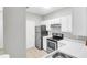Well-lit kitchen with white cabinets, stainless steel appliances, and ample counter space at 1600 Long Grove Dr # 423, Mount Pleasant, SC 29464