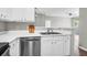 Open kitchen with stainless steel dishwasher, white cabinets, and a double-basin sink at 1600 Long Grove Dr # 423, Mount Pleasant, SC 29464