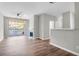 Open living room features a fireplace, wood floors, neutral paint, and a sliding door leading to a balcony at 1600 Long Grove Dr # 423, Mount Pleasant, SC 29464