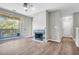 Bright living room features a fireplace with decorative tile, a ceiling fan, and sliding glass doors to the balcony at 1600 Long Grove Dr # 423, Mount Pleasant, SC 29464