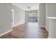 Bright and airy living room with wood floors, fireplace, ceiling fan, and sliding door leading to the balcony at 1600 Long Grove Dr # 423, Mount Pleasant, SC 29464