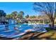 Community pool with lounge chairs and umbrellas, set amongst mature trees and manicured lawn at 1600 Long Grove Dr # 423, Mount Pleasant, SC 29464