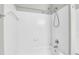 Bright white tiled shower and tub with chrome showerhead at 1600 Long Grove Dr # 423, Mount Pleasant, SC 29464