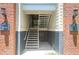 Exterior stairwell entrance to the upper level condos, featuring brick columns and signage at 1600 Long Grove Dr # 423, Mount Pleasant, SC 29464