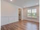 Bright dining room with hardwood floors, large window, and custom white wall trim details at 1619 Cultivation Ln, Mount Pleasant, SC 29466