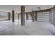 Spacious garage with concrete floor and modern roll-up doors at 1619 Cultivation Ln, Mount Pleasant, SC 29466