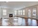 A spacious room with plantation shutters, fireplace, hardwood floors, and plenty of natural light at 1619 Cultivation Ln, Mount Pleasant, SC 29466
