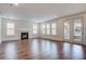Bright living room featuring hardwood floors, a fireplace, and access to an outdoor area through sliding doors at 1619 Cultivation Ln, Mount Pleasant, SC 29466