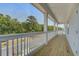 Covered porch features wooden floors, white columns, and beautiful views of the community at 1619 Cultivation Ln, Mount Pleasant, SC 29466