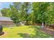 Landscaped backyard with lawn, fencing and mature shade trees at 1666 Sparkleberry Ln, Johns Island, SC 29455