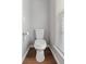 Powder room featuring wood-look flooring and white toilet with a window above at 1666 Sparkleberry Ln, Johns Island, SC 29455