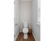 Powder room featuring white toilet, wood look flooring and window at 1666 Sparkleberry Ln, Johns Island, SC 29455