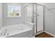 Modern bathroom featuring a separate shower and tub under a window offering an outside view at 1666 Sparkleberry Ln, Johns Island, SC 29455