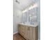 Bathroom showcasing a double sink vanity with wood cabinets, granite countertops, and modern lighting at 1666 Sparkleberry Ln, Johns Island, SC 29455