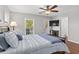 Bright bedroom with a comfortable bed, natural light from windows, ceiling fan, and TV at 1666 Sparkleberry Ln, Johns Island, SC 29455