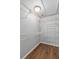 Walk in closet with wood floor and extensive wire shelving for plenty of storage space at 1666 Sparkleberry Ln, Johns Island, SC 29455