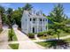 Charming two-story home with a double porch, lush landscaping, and a detached garage at 1666 Sparkleberry Ln, Johns Island, SC 29455