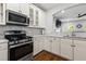 Modern kitchen featuring stainless appliances, white cabinetry, and granite countertops at 1666 Sparkleberry Ln, Johns Island, SC 29455