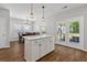 Open kitchen with a center island, wooden floors, stainless appliances, and adjacent dining area at 1666 Sparkleberry Ln, Johns Island, SC 29455