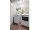 Laundry room featuring a full-size washer and dryer with wood look flooring at 1666 Sparkleberry Ln, Johns Island, SC 29455