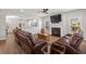 Open-concept living room with fireplace, hardwood floors, and seamless access to the modern kitchen at 1666 Sparkleberry Ln, Johns Island, SC 29455