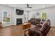 Bright living room with cozy seating, fireplace, and large windows at 1666 Sparkleberry Ln, Johns Island, SC 29455