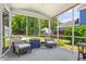 Relaxing screened-in porch with comfortable seating and views of the backyard and lush landscaping at 1666 Sparkleberry Ln, Johns Island, SC 29455