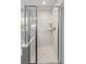 Modern bathroom showcasing a glass-enclosed shower featuring white tiles and modern showerhead at 1666 Sparkleberry Ln, Johns Island, SC 29455