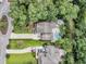 Aerial view of a home, manicured lawn, and a refreshing pool, nestled among green trees at 1728 Wellstead St, Mount Pleasant, SC 29466