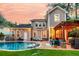 A beautiful backyard pool and pergola create an outdoor oasis for relaxation and entertainment at sunset at 1728 Wellstead St, Mount Pleasant, SC 29466